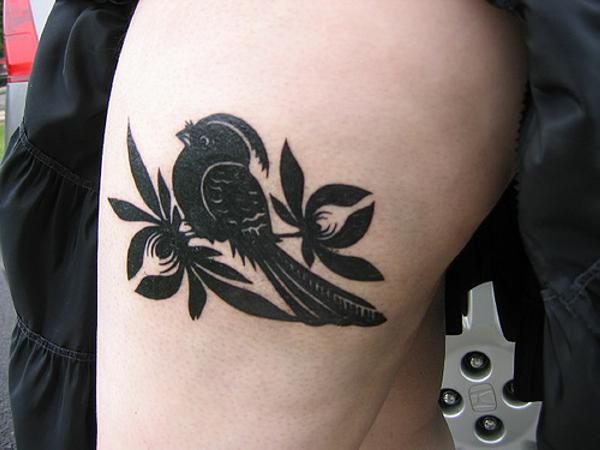 Bird tattoo on hip