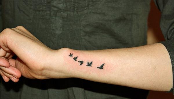 Small bird tattoo on wrist