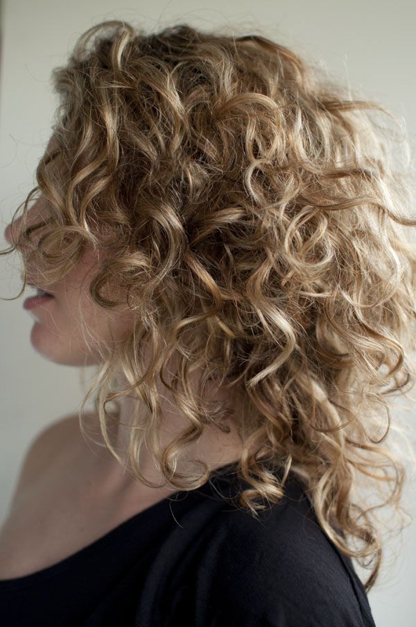 Side View of Shoulder Length Soft Curly Hairstyle for One Shoulder Dress