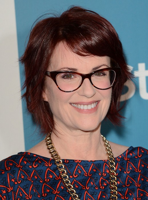 Megan Mullally Layered Short Red Haircut with Side Swept Bangs for Women Over 50