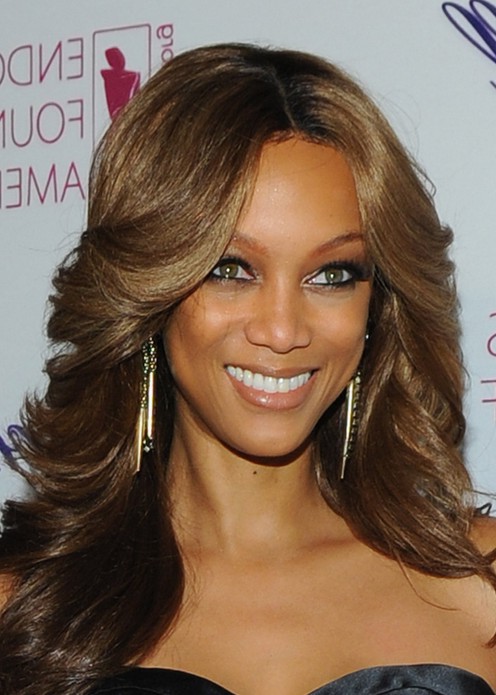 Tyra Banks Caramel Highlighted Feathered Flip Hairstyle for Women