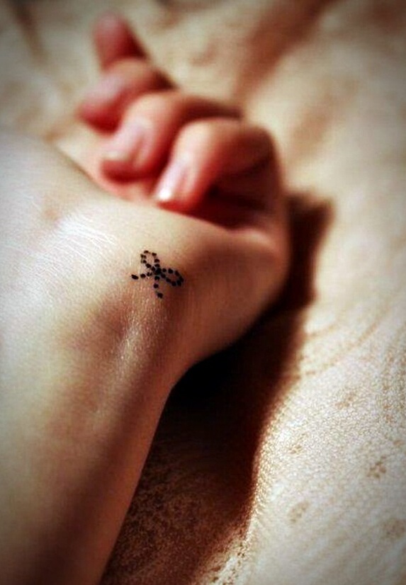 small dot bow tattoo for women