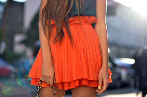 Orange pleated mini skirt