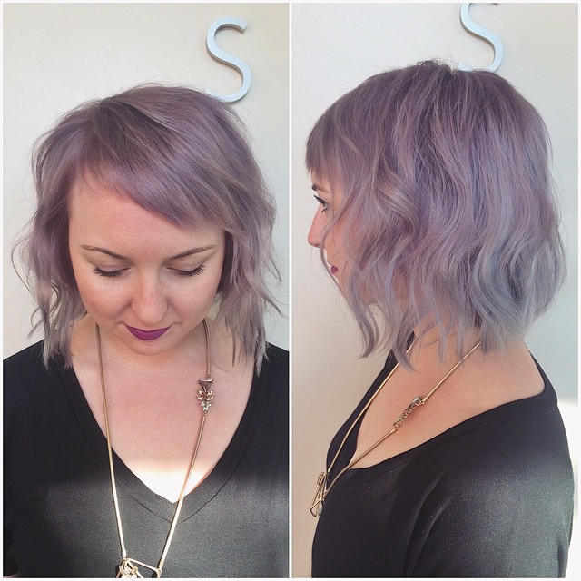 short soft wavy purple bob hairstyle with side swept bangs for round face shapes
